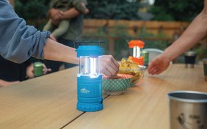 A Lantern sites atop a picnic table
